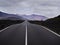 Empty endless highway through the volcanic landscape of Lanzarote island