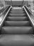 Empty escalator in the airport monochrome. Escalator in subway black and white. Electric staircase in perspective.