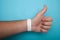 Empty event ticket wrist band design. White blank paper wristband, bracelet mockup on blue background