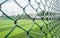 Empty fenced soccer field in cloudy summer