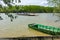 Empty ferry boat is crossing the river, fishing boats are beache