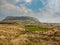 Empty field byKnocknarea Mountain with Queen Maeves Grave and Strandhill town,