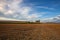 On the empty field after harvesting in summer evening