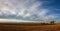 On the empty field after harvesting in summer evening