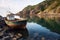 empty fishing boat anchored in rocky bay