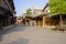Empty flagstone-paved street between old-fashioned buildings in