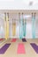 Empty flying yoga studio with colourful hammocks with colourful yoga mats on wooden texture floor at yoga studio in Bangkok