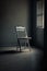 An empty folding chair in an empty dark room.