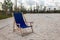 Empty folding deckchair on the edge of the beach volleyball court.