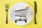 Empty food cart on white plate. Grocery shopping concept, weekly meal planning concept