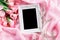 Empty frame with a bouquet sweet pink roses petal on sof