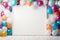 Empty frame surrounded by bright vibrant multicolored balloons and confetti