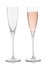 Empty and full pink rose champagne crystal glasses on white background