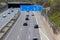 Empty German Autobahn in Dusseldorf with blue street signs and white arrows without traffic jam shows multiple lane highway ready