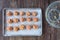 Empty glass bowl, raw turkey mixture meatballs on a parchment paper lined baking tray