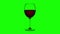 Empty glass fills up with red wine on green background