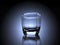 Empty glass in front of backlit dark background