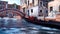 Empty gondola anb old bridge over canal in Venice