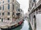 Empty gondolas on a small Venetian canal.