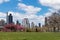 An Empty Grass Field at Rainey Park during Spring in Astoria Queens New York with the Roosevelt Island and Upper East Side Skyline
