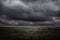 Empty grassland and dark cloud before storm