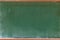 Empty green chalkboard texture hang on the white wall. double frame from greenboard and white background.