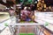 Empty green shopping cart with abstract supermarket