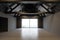 Empty grey attic room with wooden ceiling