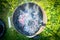 Empty Grill with coals and smoke on a background of green grass, top view, outdoor