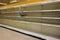 Empty grocery store shelves of bottled water before a hurricane or snow storm.  before a hurricane or snow storm