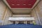 Empty hall with blue carpet and red ornament on the ceiling