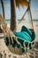 An empty hammock on a beautiful tropical beach. Relaxing, calm summer vacation. Generative ai
