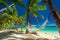 Empty hammock in the shade of palm trees on tropical Fiji