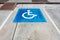 Empty handicapped reserved parking space with wheelchair symbol