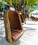 Empty hanging wicker chair on tropical beach