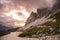 Empty high mountain path under dramatic sky at sunset