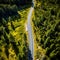 An empty highway is captured from a top-down perspective, offering an aerial view of the great landscape it traverses