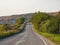 An empty highway country road among beautiful autumn hills