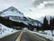 An empty highway on a snowy winter landscape going through the rocky mountains on a nice winter day in jasper national park