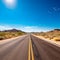 empty highway stretches ahead with parallel lines disappearing into the great landscape.