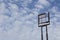 Empty highway tall sign frame against a blue sky with clouds, copy space