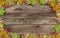 Empty horizontal wooden planks board poster with frame made of leaves, concept of fall autumn sale or back to school