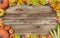 Empty horizontal wooden planks poster with frame made of leaves, pumpkins and corn, concept of fall autumn sale or back to school