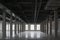 Empty huge open space in old factory building with rows of columns, big windows and pipes on the ceiling