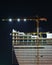 Empty illuminated construction site and crane at night