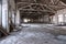 Empty industrial loft in an architectural background with bare cement walls, floors and pillars