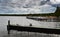 Empty jetty at Arendsee lake in Germany in cold weather under dark cloudy sky