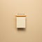 Empty kraft notepad with colored pencil on beige background