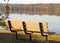 Empty lakeside bench in early morning fall sunlight