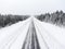 Empty lane of northern asphalt highway at winter blizzard. Northern Karelia, Russia